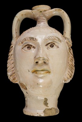 Lot 165 - Flask. A novelty flask in the form of a mans head, probably 19th century