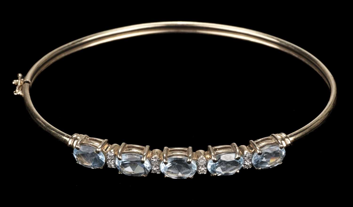 Lot 468 - Bangle. 9ct gold bangle, set with 5 topaz stones