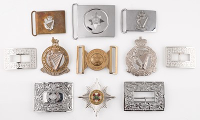 Lot 436 - Irish Guards. A modern helmet plate of the Irish Guards and other Irish buckles and badges